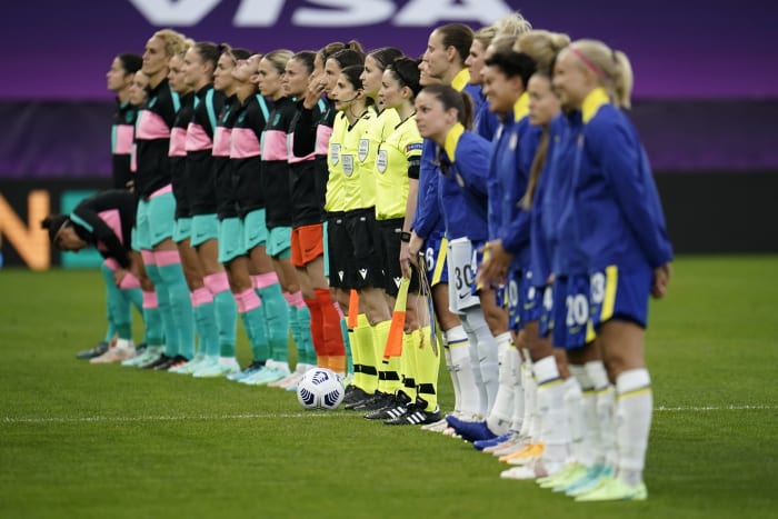 Players from Barcelona and Chelsea pictured lining up before the 2020/21 UEFA Women's Champions League final in Gothenburg, Sweden